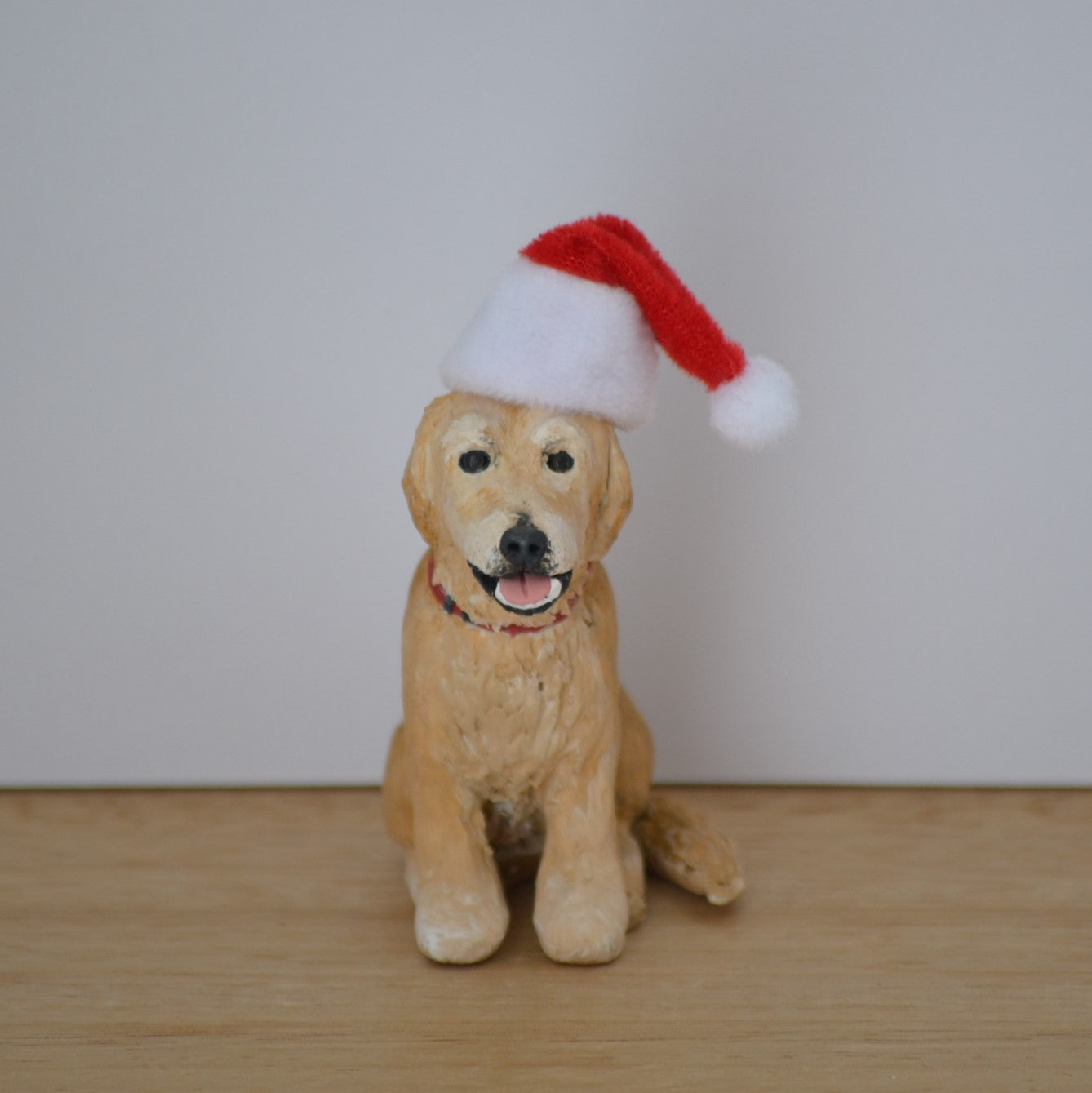 Handmade custom golden retriever dog figurine with santa hat