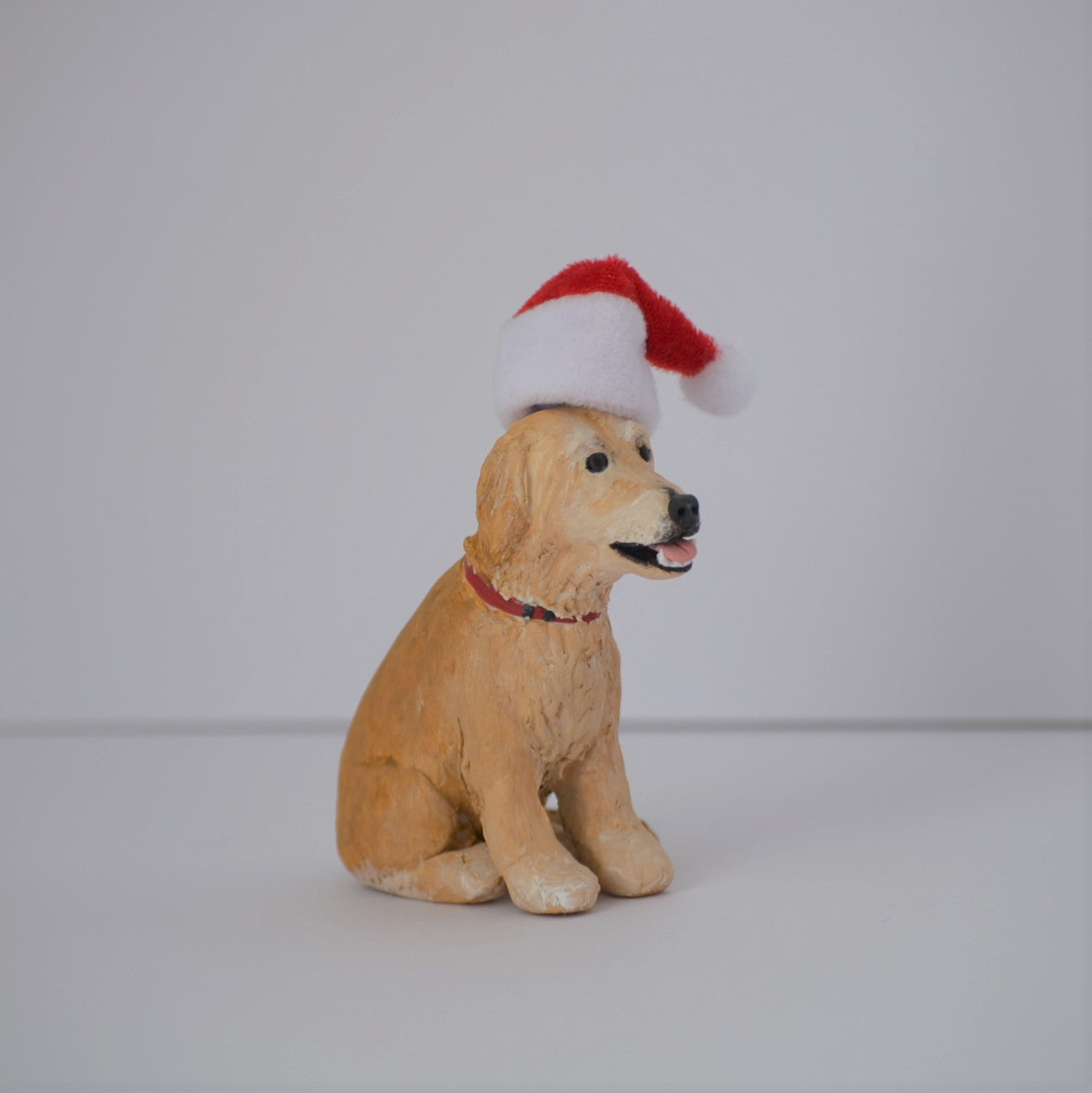 Handmade custom golden retriever dog figurine with santa hat
