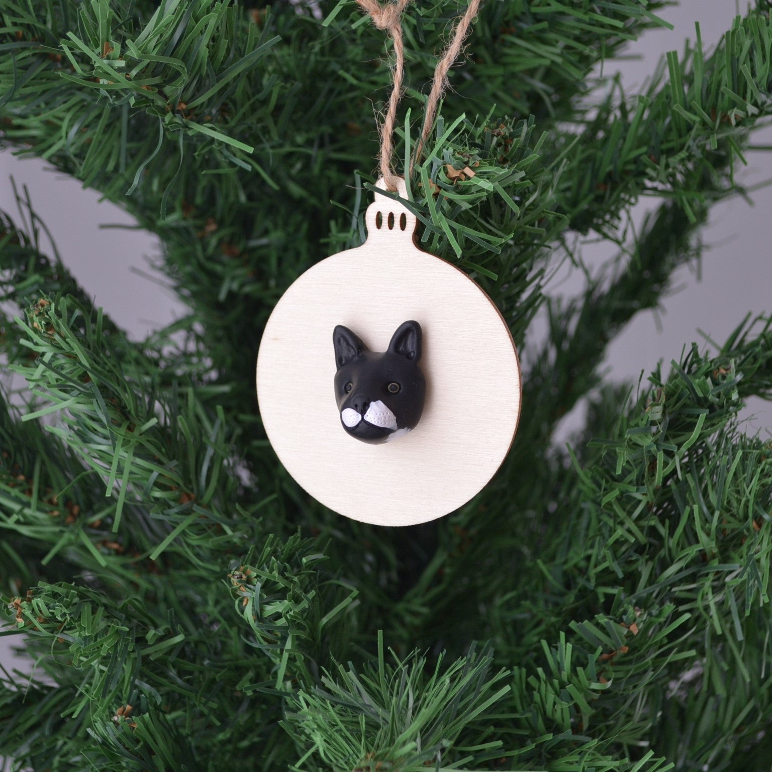 Bauble shaped christmas ornament with a handmade polymer clay cat face attached