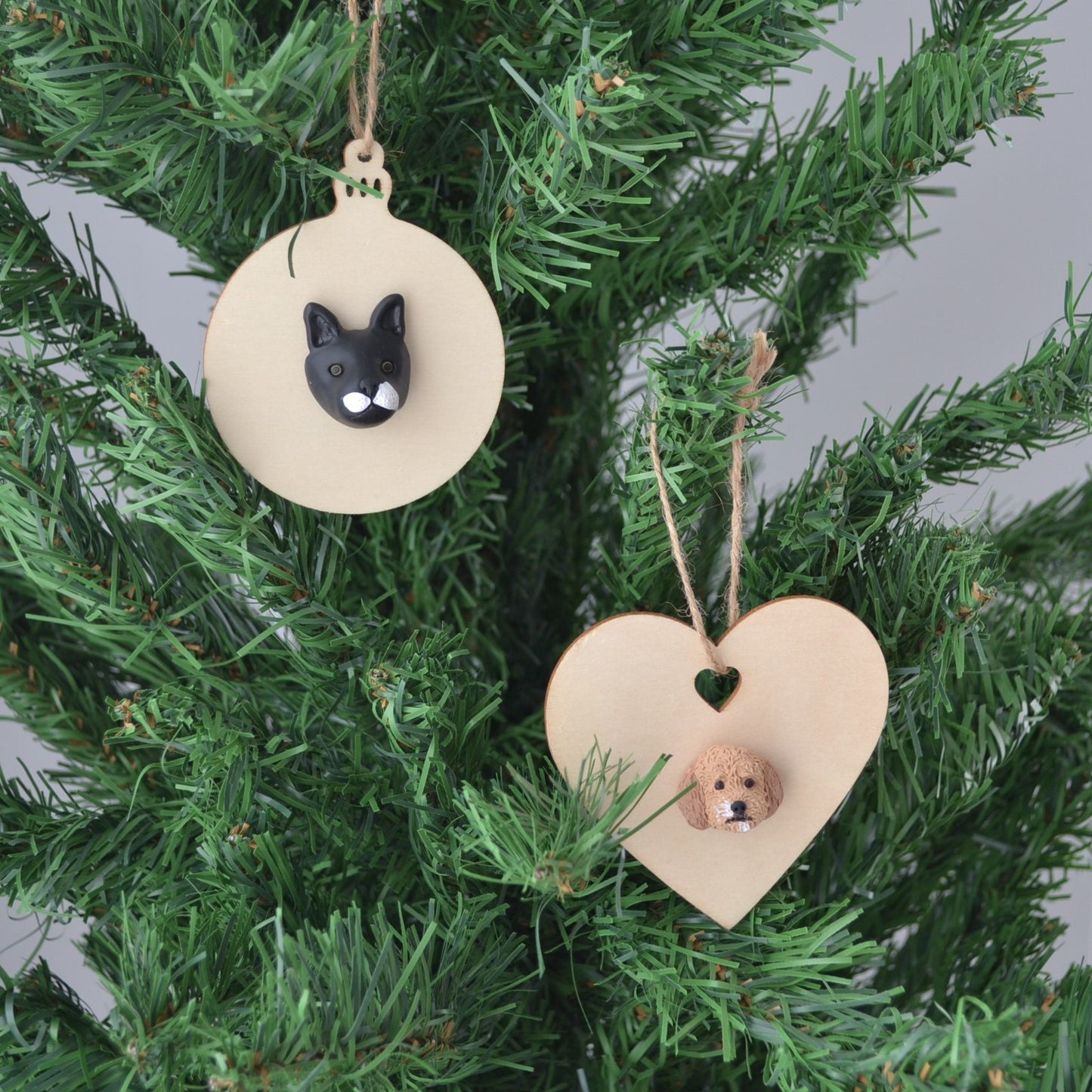 Handmade custom pet christmas ornaments hanging in a christmas tree.