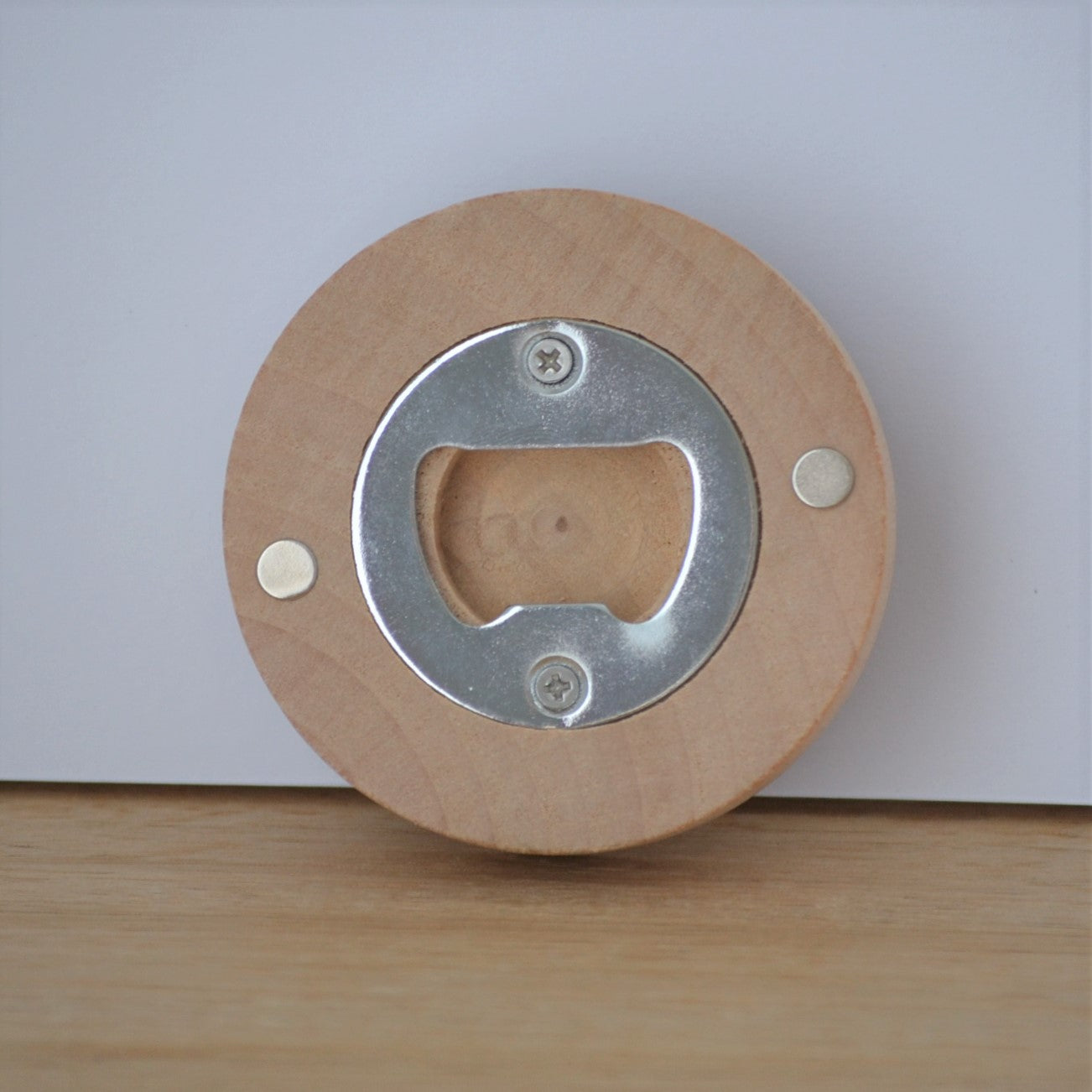 Timber bottle opener shown from back, displaying magnets