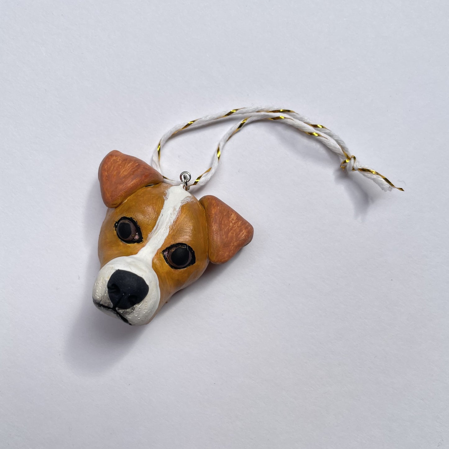 Handmade Christmas hanging ornament resembling the face of a Jack Russell.