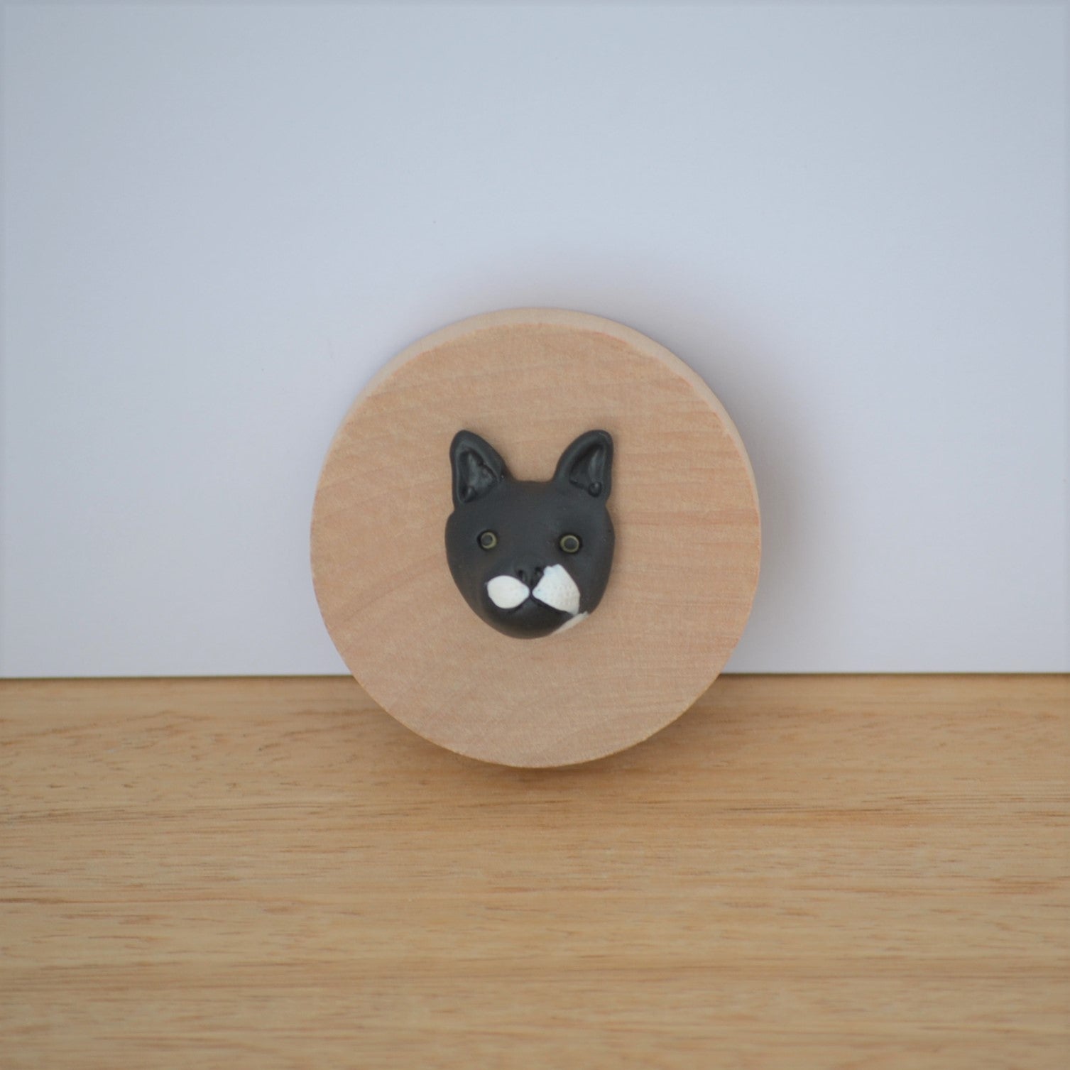 Bottle opener with custom black cat face sculpture attached