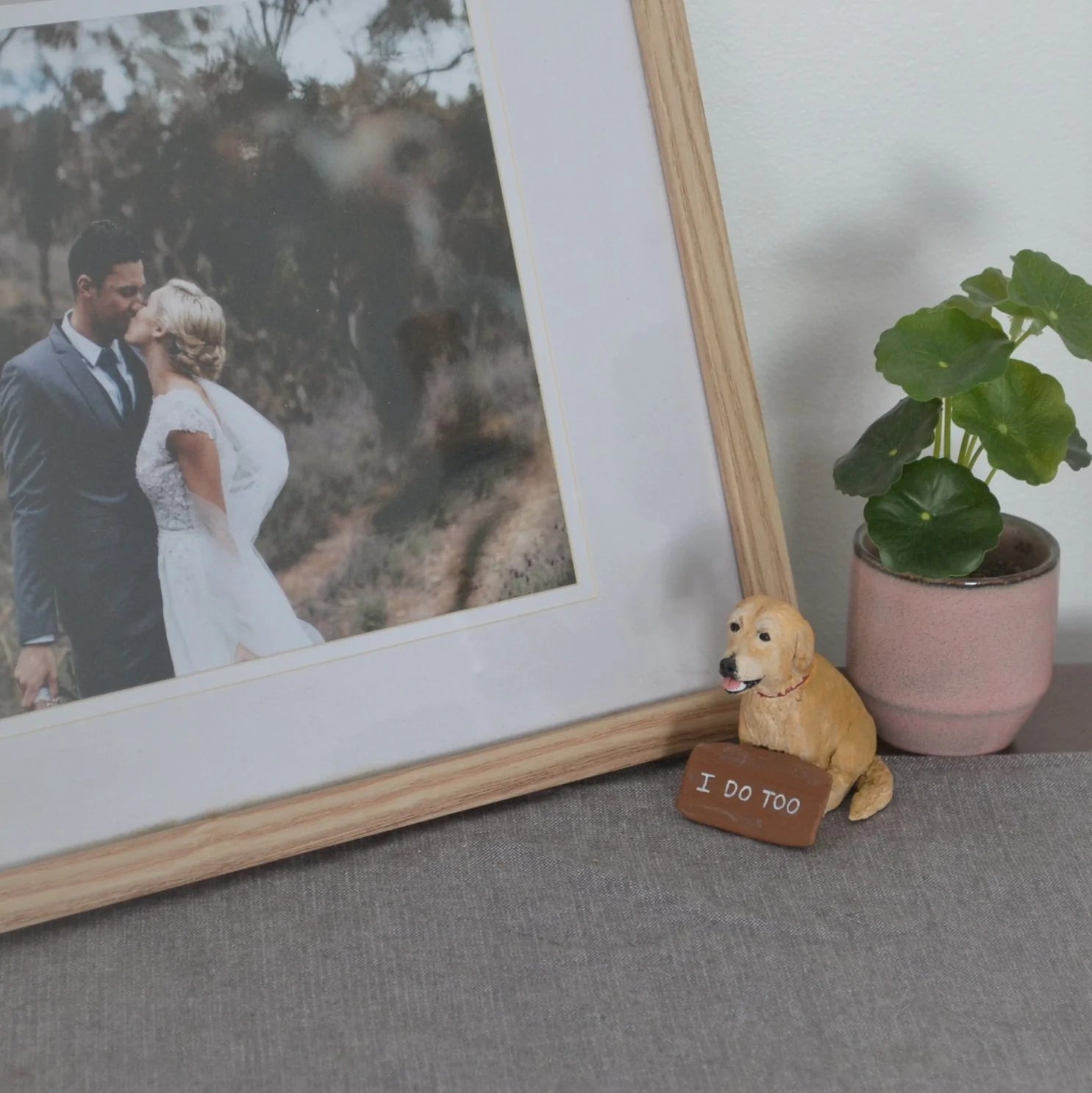 Handmade Golden retriever dog figurine beside a photo frame