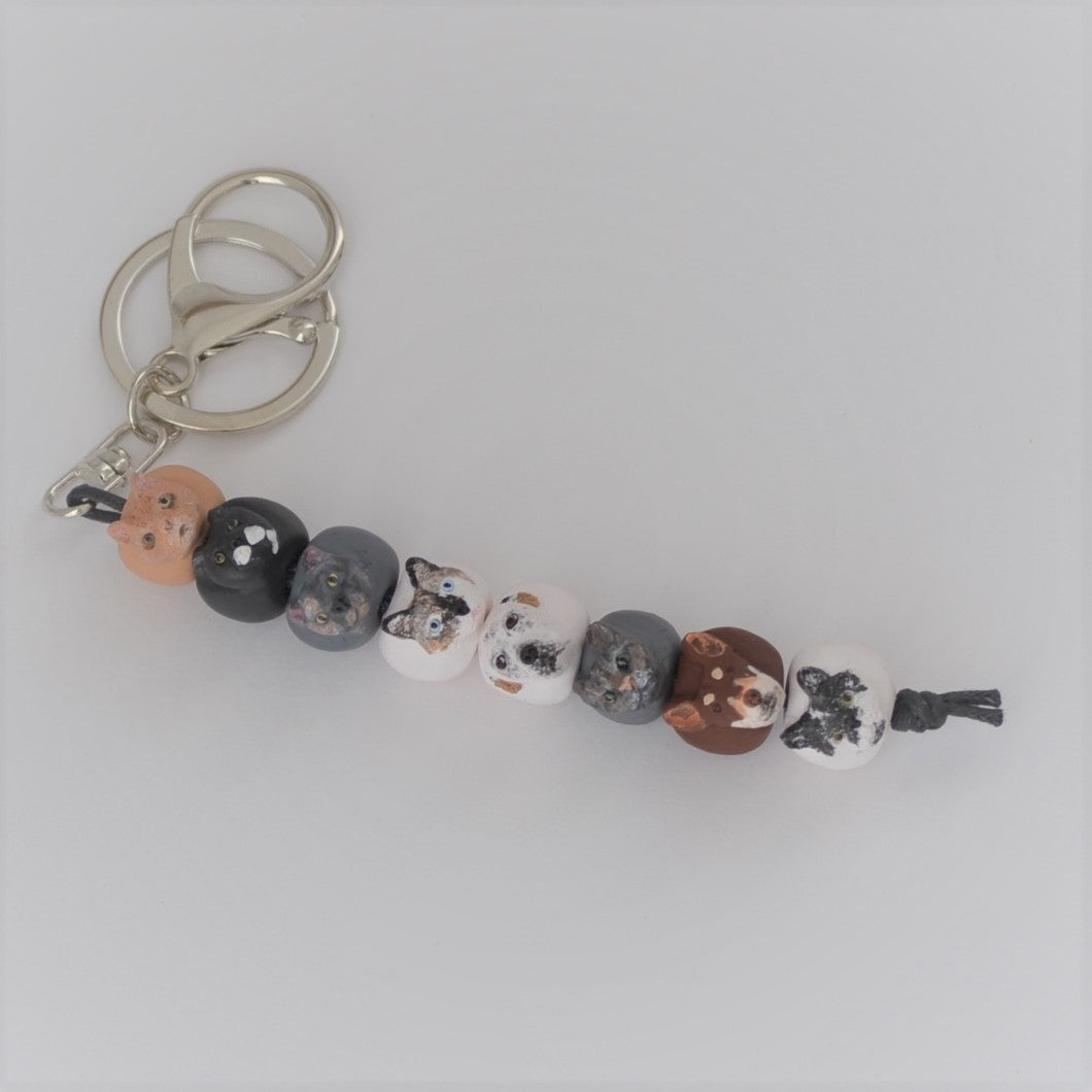 Handmade custom pet keyring with 8 individual dog face beads.