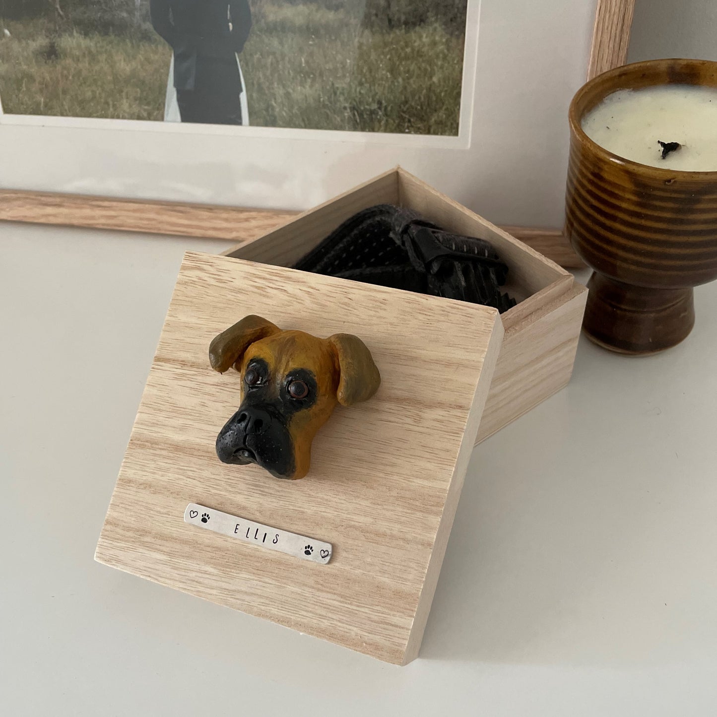 Custom timber pet memorial keepsake box with handscultped dog face on the lid, with a name plaque reading Ellis.
