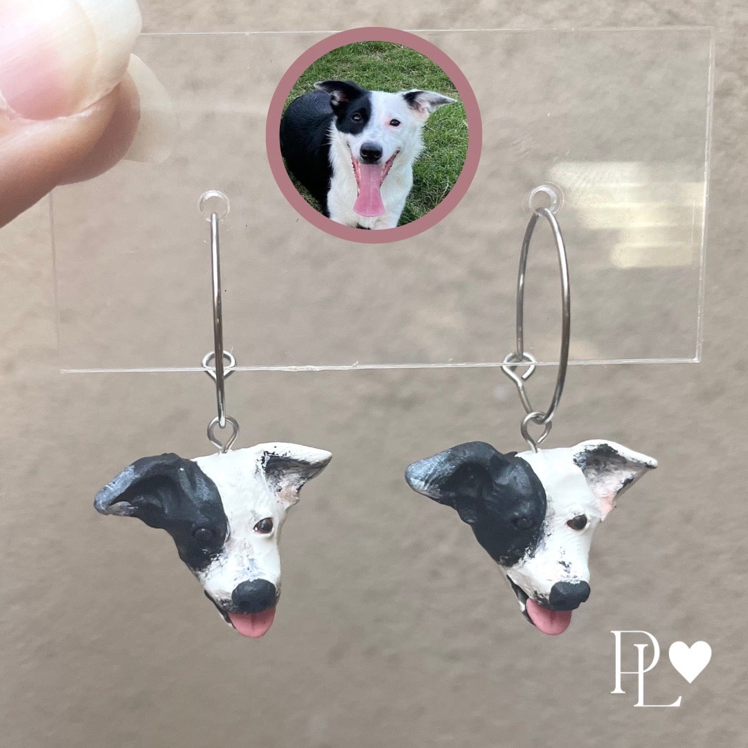 Handmade polymer clay dangle custom pet earrings of a black and white dog.