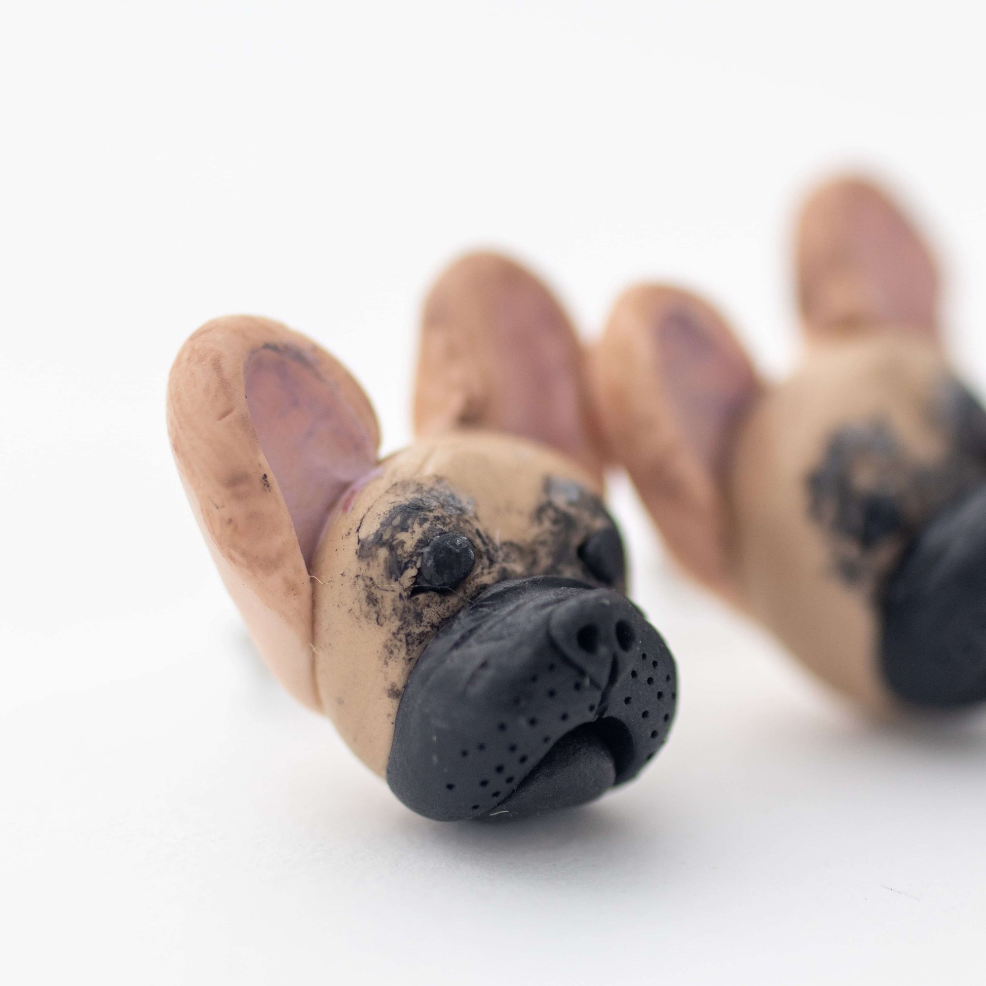 Handmade polymer clay french bulldog stud earrings shown up close