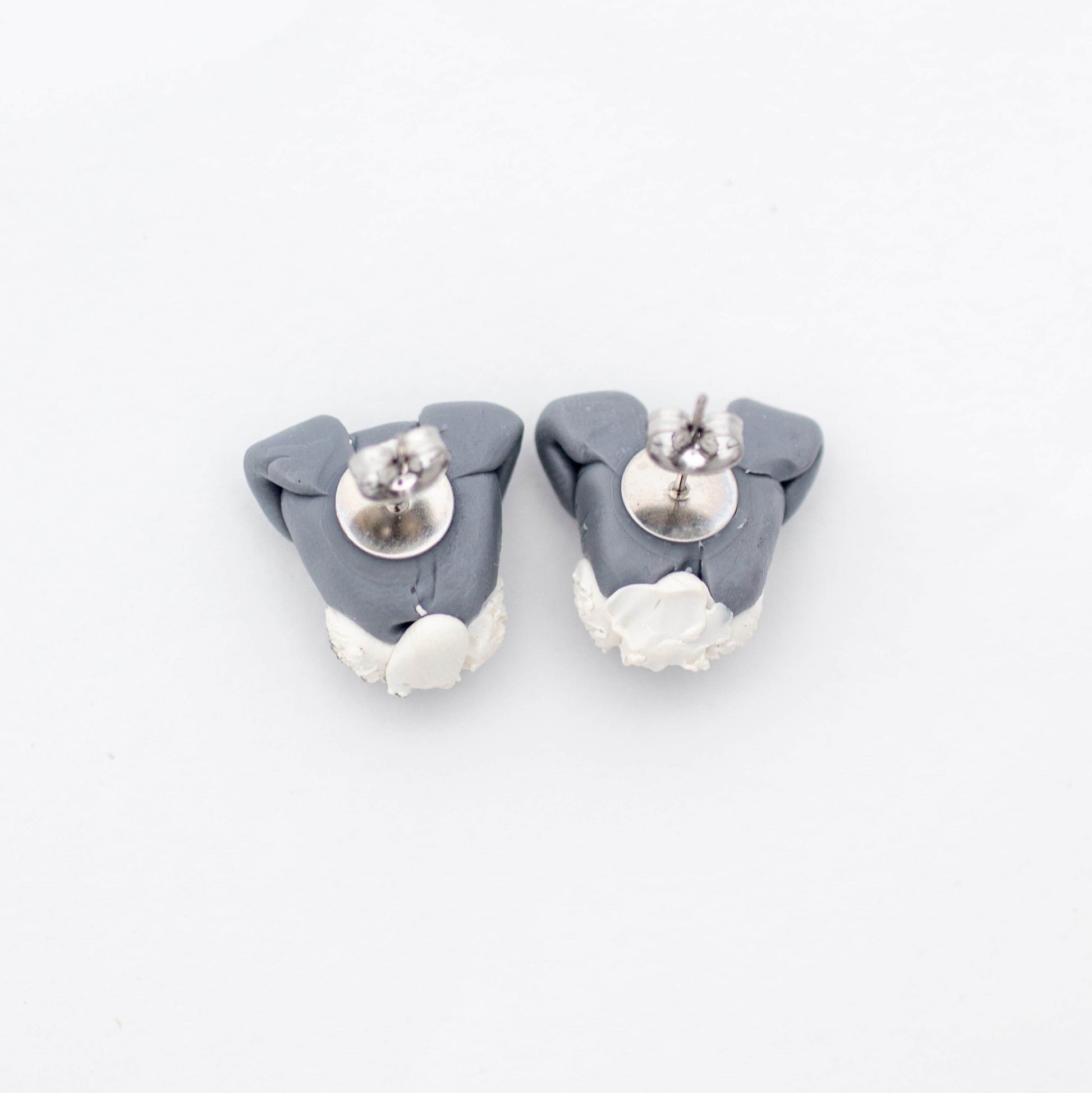 Handmade polymer clay schnauzer stud earrings showing surgical steel backs