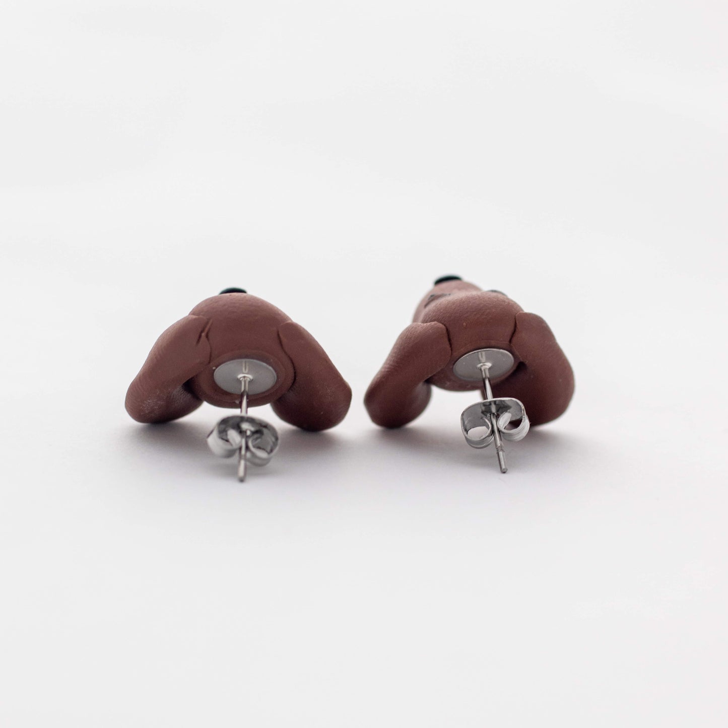 Handmade polymer clay Dachshund stud earrings showing surgical steel backs