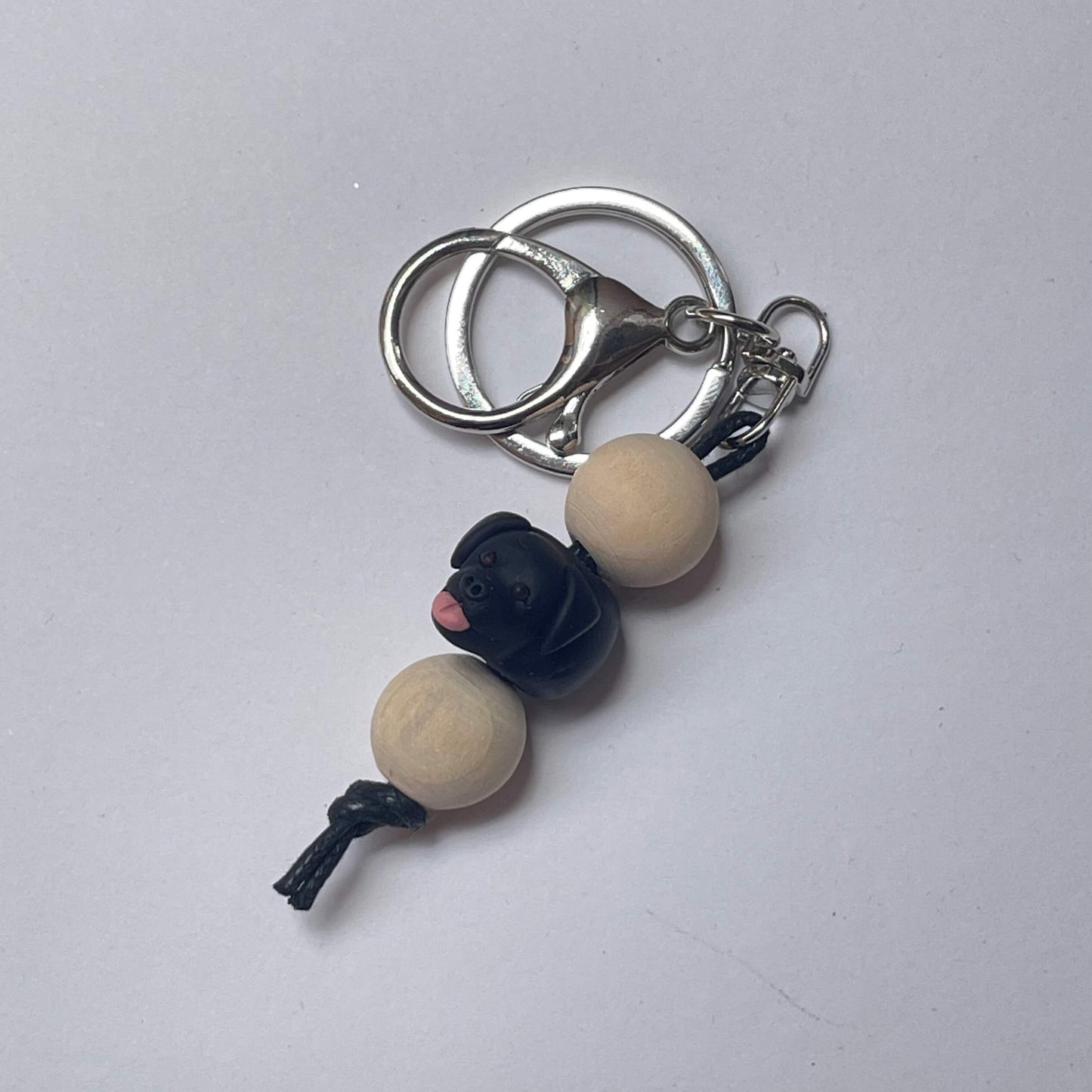 Handmade black labrador timber and polymer clay keychain on a white background