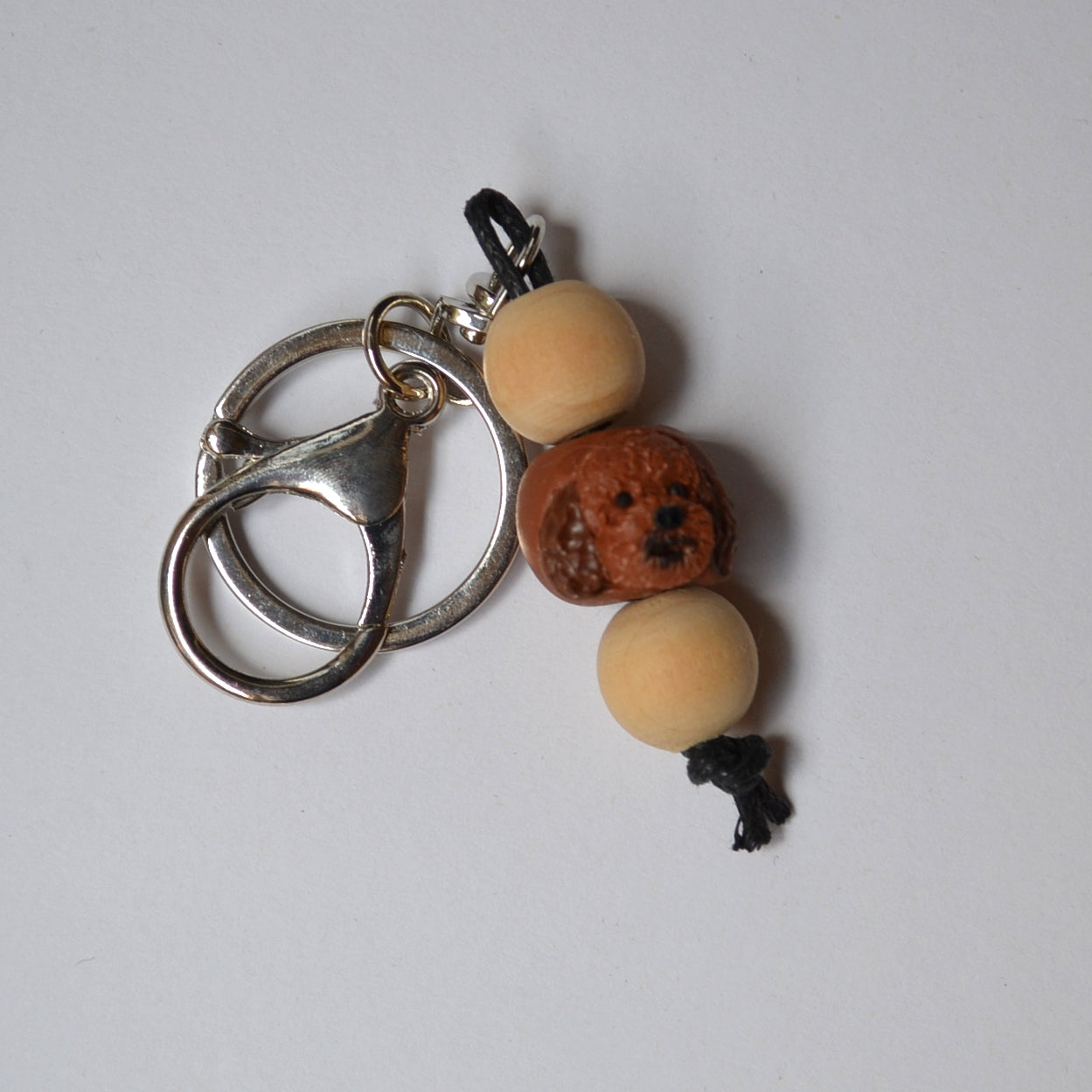 Handmade timber and polymer clay cavoodle dog keychain on white background