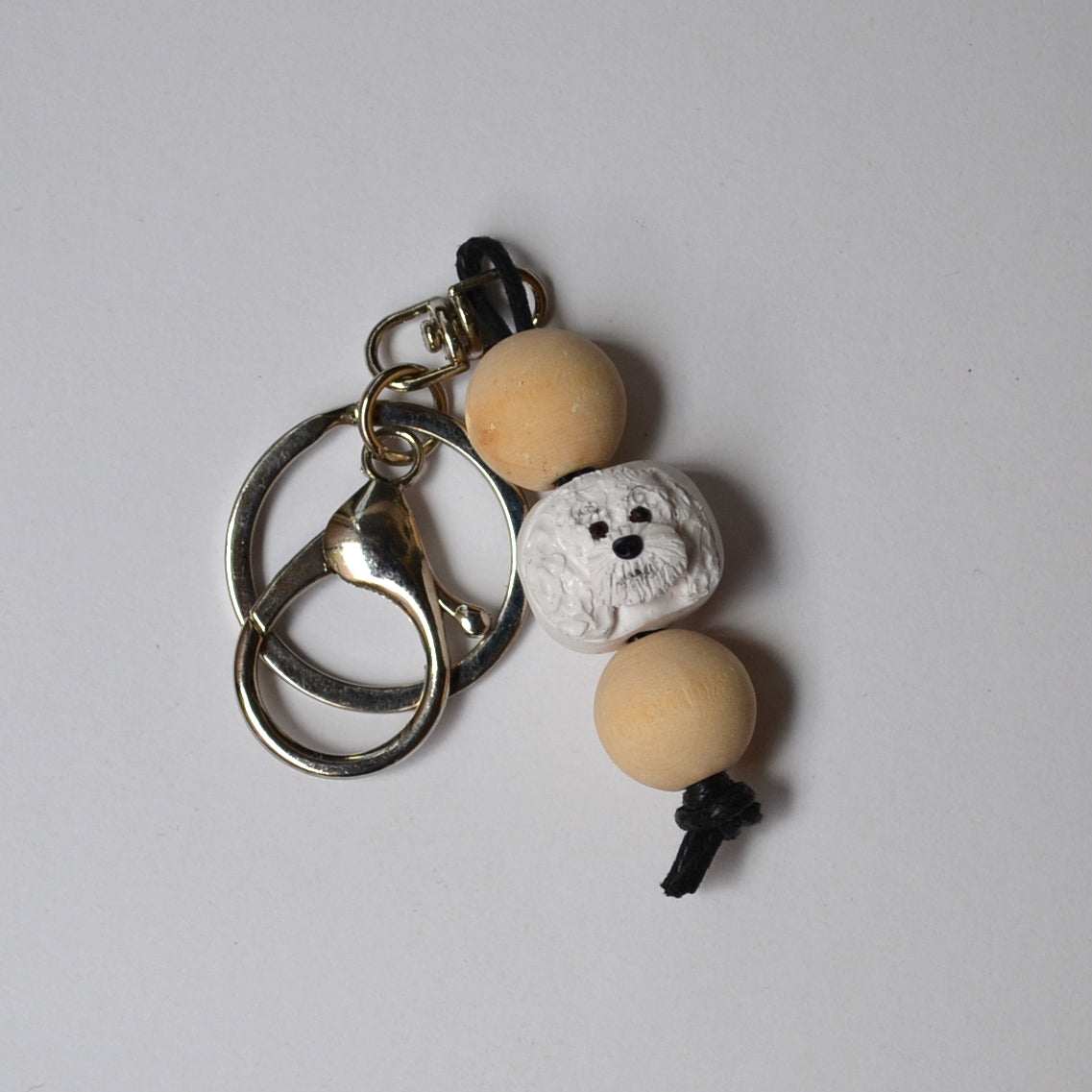 Handmade timber and polymer clay white poodle dog keychain on white background
