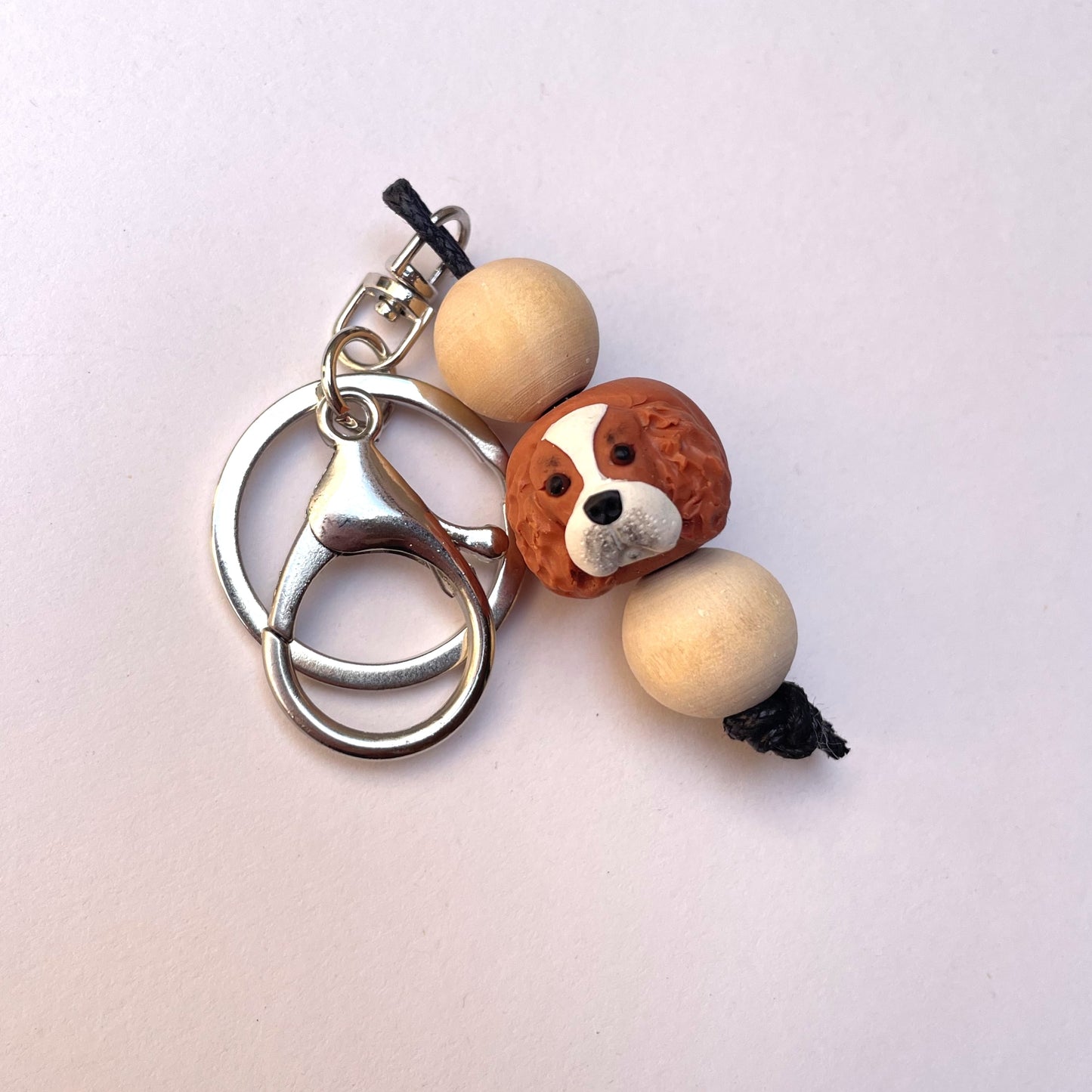 Polymer clay and timber handmade cavalier king charles spaniel dog keyrings on white background