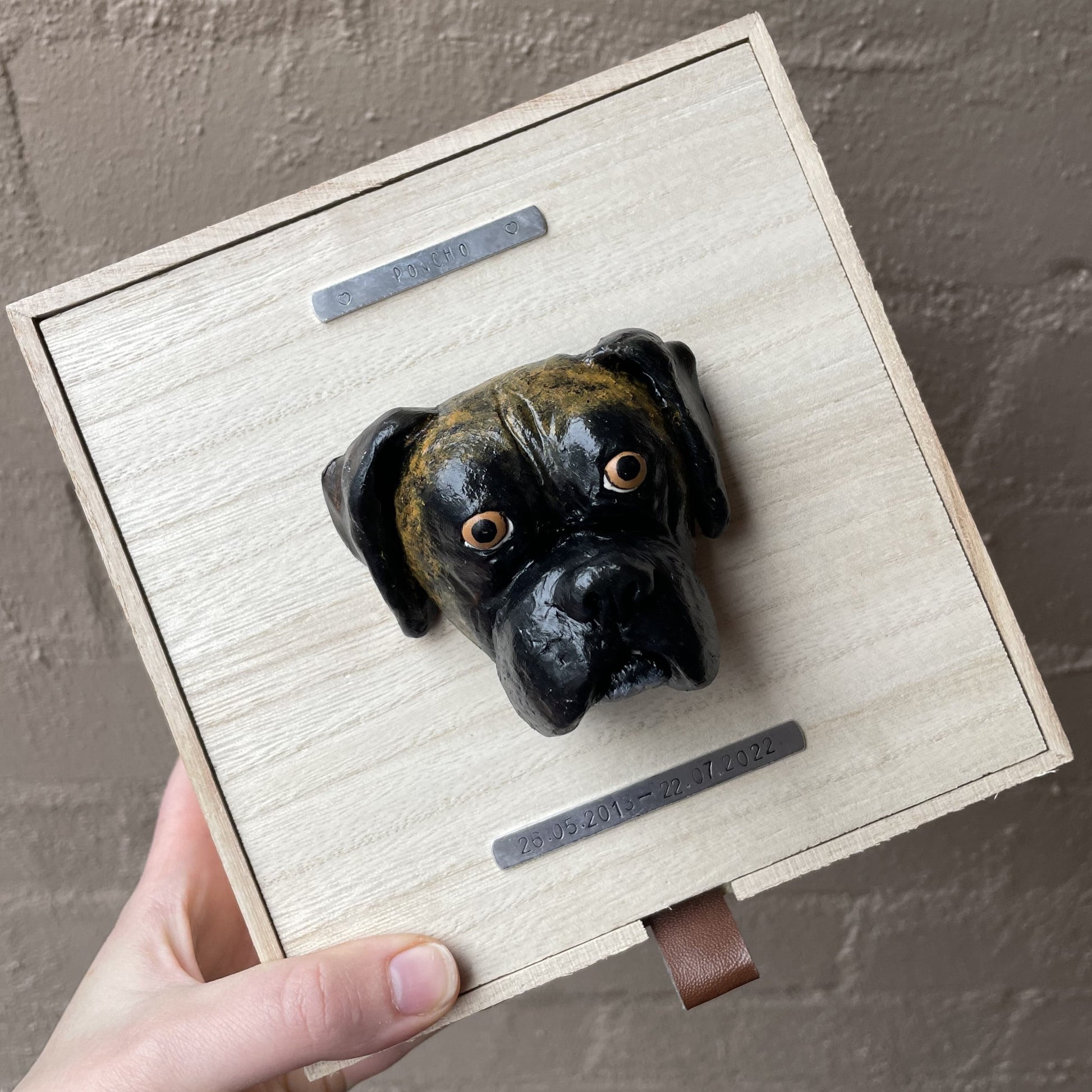 Custom timber pet memorial keepsake box with handscultped dog face on the lid, with a name plaque reading Poncho.
