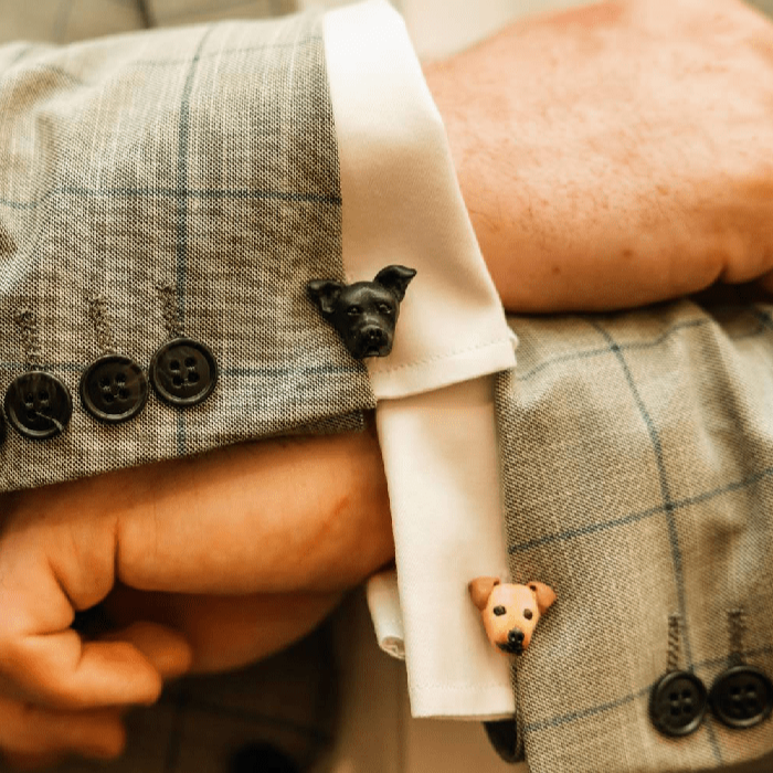 Mismatched custom dog cufflinks shown on groom wearing grey suit