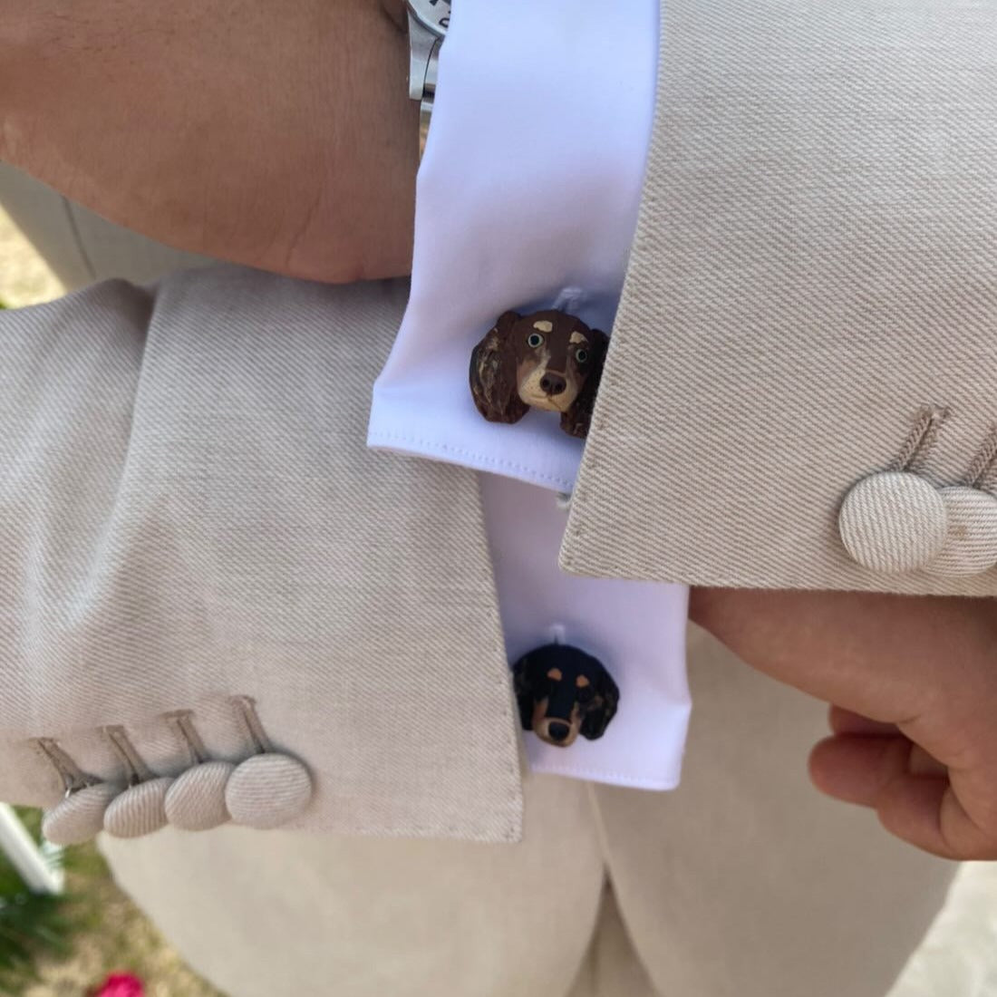 Mismatched dog cufflinks being worn by the groom at a wedding
