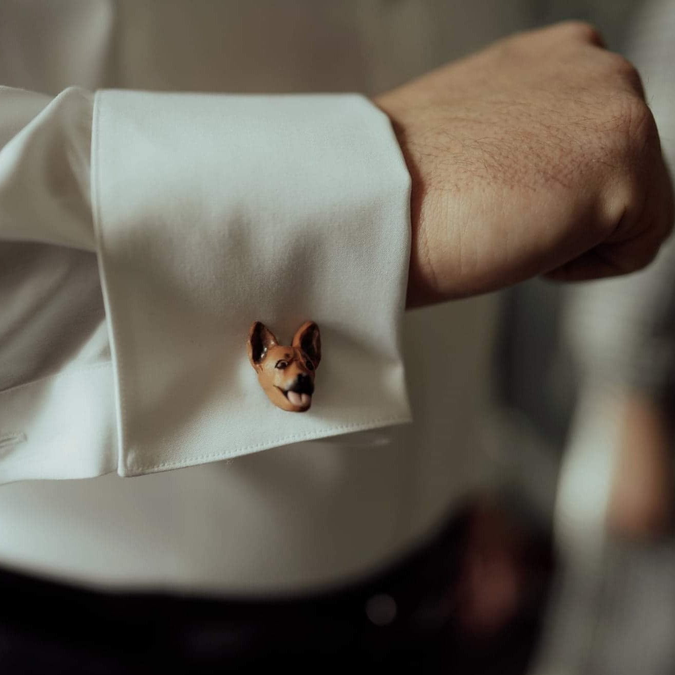 Custom dog cufflinks shown being worn at a wedding